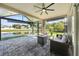 Enjoy the outdoors on this screened patio with comfortable seating and views of the lake at 5131 Gato Del Sol Cir, Wesley Chapel, FL 33544