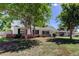 Charming home exterior with mature trees, brick accents, and a well-manicured lawn at 565 55Th Ne Ave, St Petersburg, FL 33703