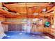 Spacious garage space with plywood walls and ceiling, with tools and household items at 565 55Th Ne Ave, St Petersburg, FL 33703