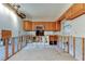 Kitchen area with oak cabinets, stainless steel microwave, unfinished drywall and flooring at 565 55Th Ne Ave, St Petersburg, FL 33703