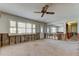 Bright living room with a ceiling fan, large window, and mirror, ready for renovation and personalization at 565 55Th Ne Ave, St Petersburg, FL 33703