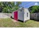 White shed with red door at 565 55Th Ne Ave, St Petersburg, FL 33703