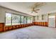Bright sunroom featuring big windows, backyard access, built in shelves and unfinished drywall at 565 55Th Ne Ave, St Petersburg, FL 33703