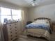 Bright bedroom with laminate floors, neutral walls, and a large window for natural light at 5970 21St N St # 15, St Petersburg, FL 33714