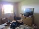 Bedroom featuring a window, and a dresser with a mirror, but needs cleaning and decluttering at 5970 21St N St # 15, St Petersburg, FL 33714