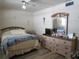 Cozy bedroom with neutral walls, laminate flooring, and a light wood dresser with mirror at 5970 21St N St # 15, St Petersburg, FL 33714