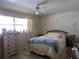 Bright bedroom with laminate floors, neutral walls, and a large window for natural light at 5970 21St N St # 15, St Petersburg, FL 33714