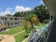 Exterior staircase overlooking the landscaped courtyard, providing a picturesque view of the community grounds at 5970 21St N St # 15, St Petersburg, FL 33714