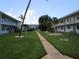 Community courtyard showcasing lush lawns, mature trees, and walkways, ideal for outdoor relaxation at 5970 21St N St # 15, St Petersburg, FL 33714