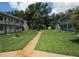 Lush courtyard features a walkway, mature trees, and neatly manicured lawns, creating a serene outdoor space at 5970 21St N St # 15, St Petersburg, FL 33714