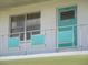 Exterior featuring a teal door and decorative panels, complemented by a well-maintained balcony at 5970 21St N St # 15, St Petersburg, FL 33714