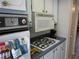Kitchen with white and blue cabinets, gas cooktop, and a retro-style oven and microwave at 5970 21St N St # 15, St Petersburg, FL 33714