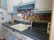Kitchen with blue countertops and white cabinets, including a sink and older appliances at 5970 21St N St # 15, St Petersburg, FL 33714