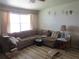 Comfortable living room featuring a large sectional sofa, bright window, and modern flooring at 5970 21St N St # 15, St Petersburg, FL 33714