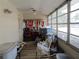 Enclosed sunroom featuring lots of natural light, a ceiling fan and wood laminate flooring at 5970 21St N St # 15, St Petersburg, FL 33714