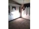 Carpeted room features cabinet and window with curtains at 6443 Midland St, Zephyrhills, FL 33542