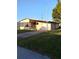 Inviting home with a covered garage, cozy front yard and driveway at 6443 Midland St, Zephyrhills, FL 33542
