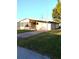Charming single-story home with a well-maintained lawn and attached garage at 6443 Midland St, Zephyrhills, FL 33542