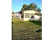 This property has a sunroom and a sprawling, green lawn area at 6443 Midland St, Zephyrhills, FL 33542