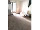 Bright living room featuring sliding glass doors and neutral carpeting at 6443 Midland St, Zephyrhills, FL 33542