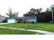 Charming single-story home with a well-manicured front lawn and brick accents at 6605 Foxmoor Dr, Zephyrhills, FL 33542
