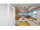 Well-lit kitchen with white cabinets, wood countertops, and modern appliances at 6605 Foxmoor Dr, Zephyrhills, FL 33542