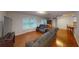 Bright living room with hardwood floors, comfortable sofas, and large windows at 6605 Foxmoor Dr, Zephyrhills, FL 33542