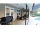 Covered patio area with ceiling fan and view of the pool and sunroom at 6605 Foxmoor Dr, Zephyrhills, FL 33542