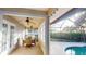Enclosed sunroom with ceiling fans, dining set, and access to the screened in pool at 6605 Foxmoor Dr, Zephyrhills, FL 33542