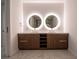 Modern bathroom featuring a double sink vanity, illuminated mirrors, and sleek fixtures at 777 3Rd N Ave # 1503, St Petersburg, FL 33701