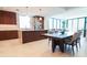 Open-concept kitchen with wood cabinetry, stainless steel appliances, and adjacent dining area at 777 3Rd N Ave # 1503, St Petersburg, FL 33701