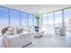 Airy living room with floor-to-ceiling windows, modern white furniture, and stunning views at 777 3Rd N Ave # 1503, St Petersburg, FL 33701
