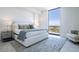 Serene bedroom featuring a luxurious bed, soft lighting, and expansive windows with city views at 777 3Rd N Ave # 1503, St Petersburg, FL 33701