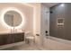 Modern bathroom with sleek gray and white tiles, lighted mirror, and tub shower at 777 3Rd N Ave # 1603, St Petersburg, FL 33701