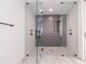 Sleek glass enclosed shower with a gray tiled back wall and rain shower head and a handheld shower at 777 3Rd N Ave # 1603, St Petersburg, FL 33701