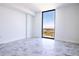 Bright bedroom featuring floor-to-ceiling windows offering expansive city views and stunning gray tiled floors at 777 3Rd N Ave # 1603, St Petersburg, FL 33701