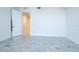 Bright room with gray tile floors and white walls, featuring an open door at 777 3Rd N Ave # 1603, St Petersburg, FL 33701