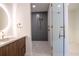 Elegant bathroom featuring modern vanity, round mirror and walk-in shower with glass door at 777 3Rd N Ave # 1704, St Petersburg, FL 33701