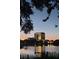 Scenic lake view of modern building with sunset glow and tree silhouettes at 777 3Rd N Ave # 1704, St Petersburg, FL 33701