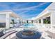 A luxurious rooftop pool area with stylish seating, landscaping, and a cozy firepit at 777 3Rd N Ave # 1704, St Petersburg, FL 33701