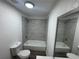 Bathroom featuring modern tile surround tub, vanity and mirror at 8018 Mulberry St, Tampa, FL 33604