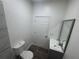 Modern bathroom with tiled shower, vanity and mirror at 8018 Mulberry St, Tampa, FL 33604