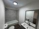 Bathroom featuring modern tile surround tub, vanity and mirror at 8018 Mulberry St, Tampa, FL 33604