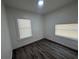 Cozy bedroom featuring two windows and new flooring at 8018 Mulberry St, Tampa, FL 33604