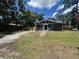 Charming single-story home with a well-maintained lawn and mature trees at 8018 Mulberry St, Tampa, FL 33604
