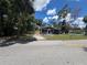 Charming single-story home with a well-maintained lawn and mature trees at 8018 Mulberry St, Tampa, FL 33604