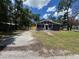 Charming single-story home with a well-maintained lawn and mature trees at 8018 Mulberry St, Tampa, FL 33604