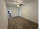 Bright living room features a ceiling fan and modern flooring at 8018 Mulberry St, Tampa, FL 33604
