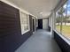 Inviting screened porch with fresh paint, new windows, and outdoor lighting at 8018 Mulberry St, Tampa, FL 33604