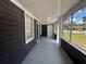 Inviting screened porch with fresh paint, new windows, and outdoor lighting at 8018 Mulberry St, Tampa, FL 33604